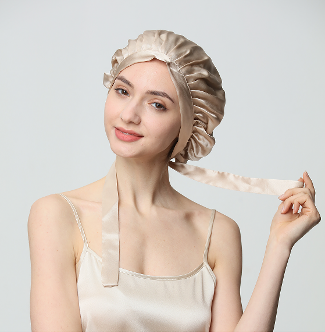 Model showing the champagne silk bonnet tie detail
