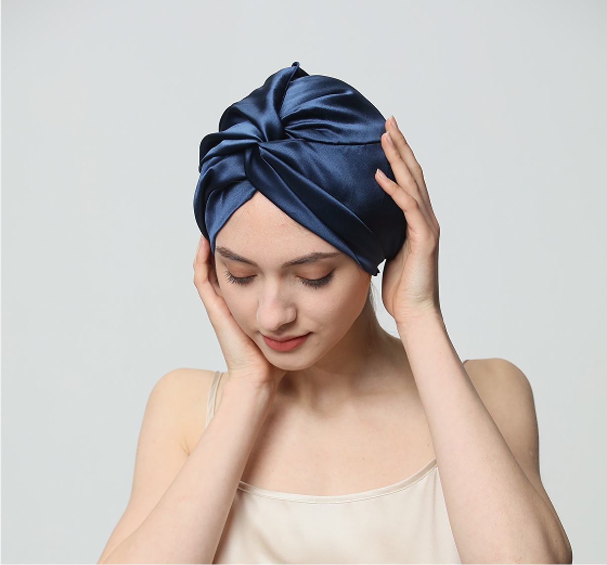 Model wearing a navy Jiasili silk bonnet