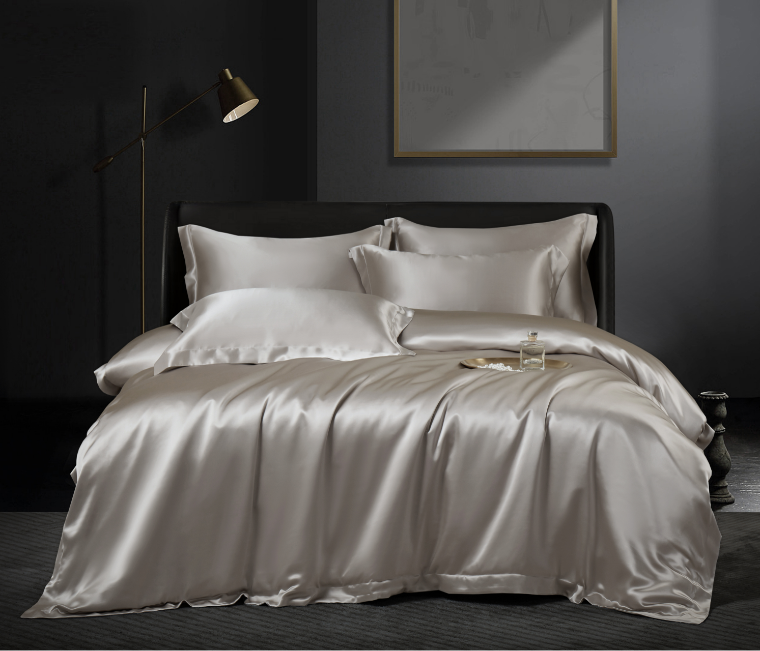 Ivory silk bedding styled in a dark bedroom