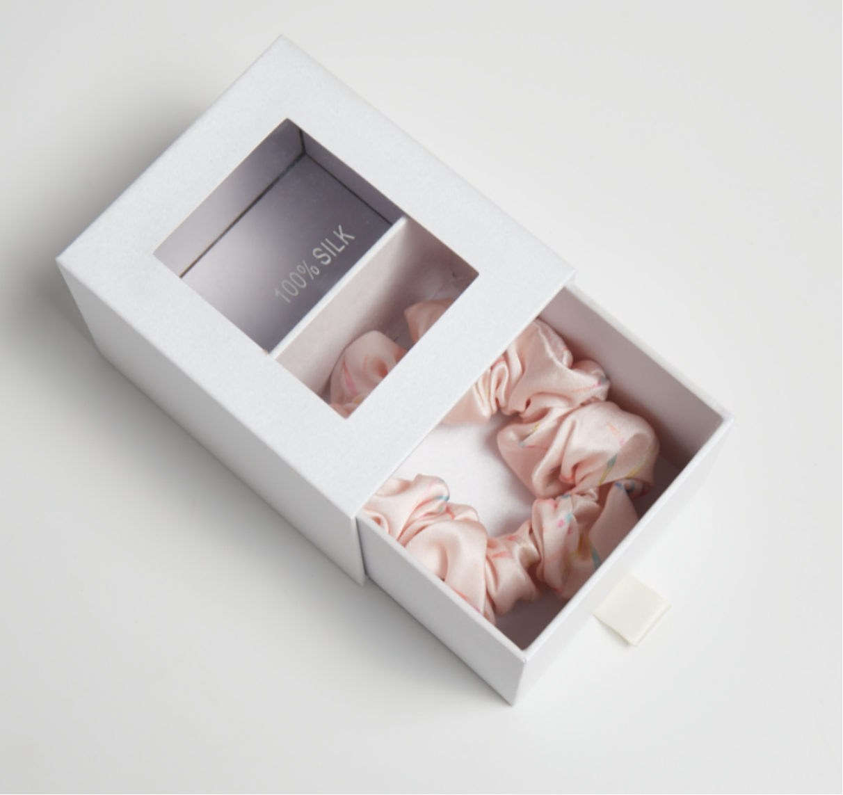 Silk scrunchies presented in a white gift box